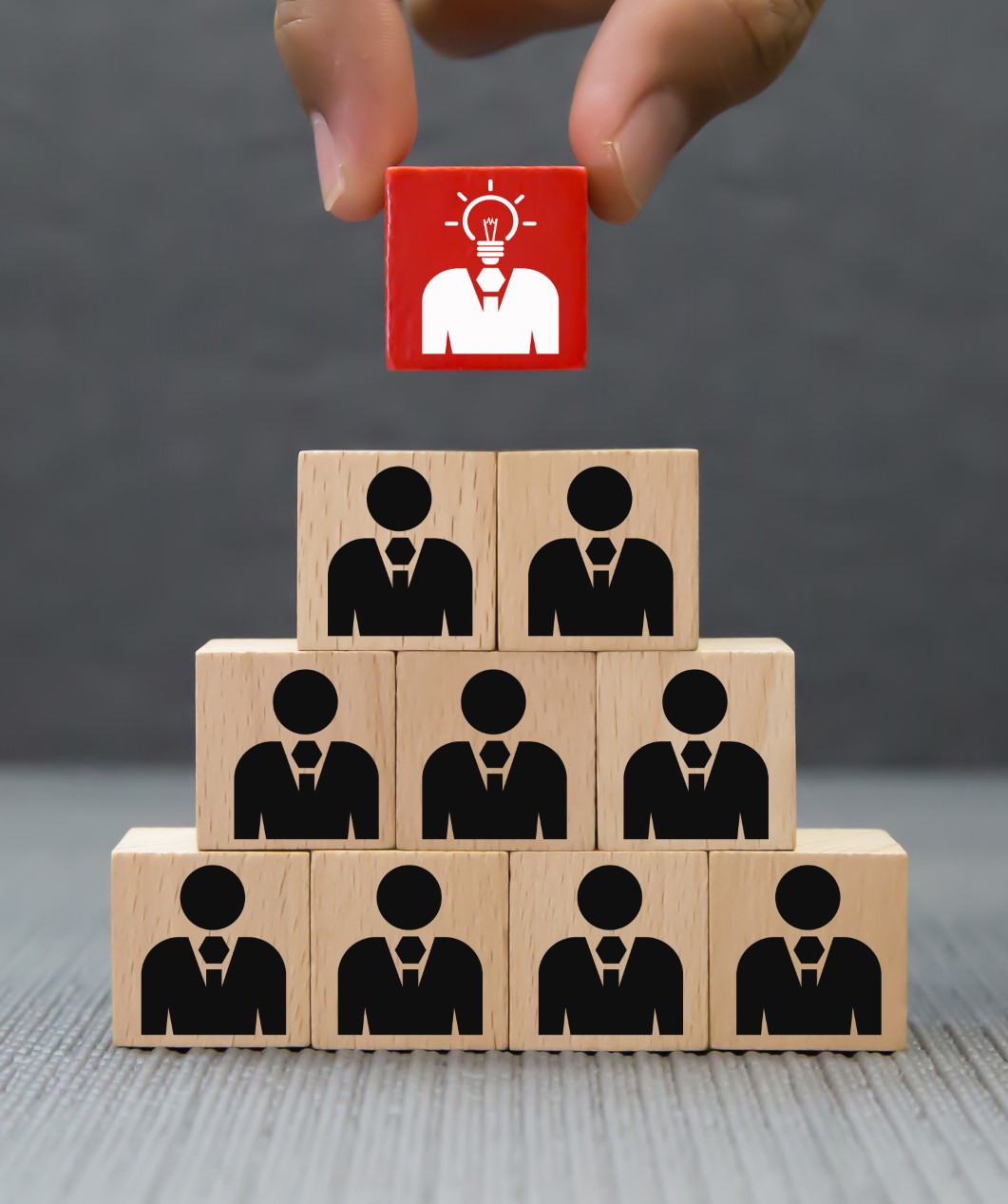 Hand choose Businessman icon on wood block.